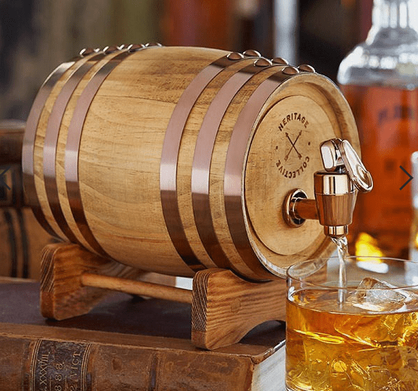 Drewniana beczka na whisky z której leje się whisky